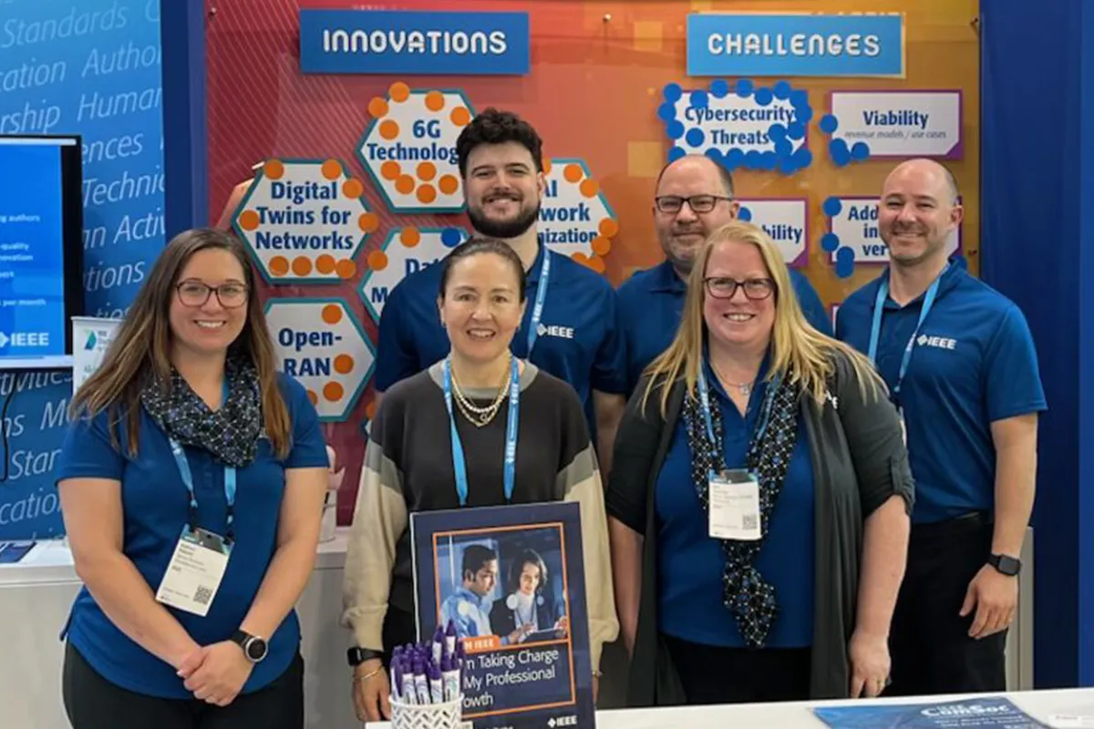 Staff and student volunteers inside the booth at Mobile World Congress
