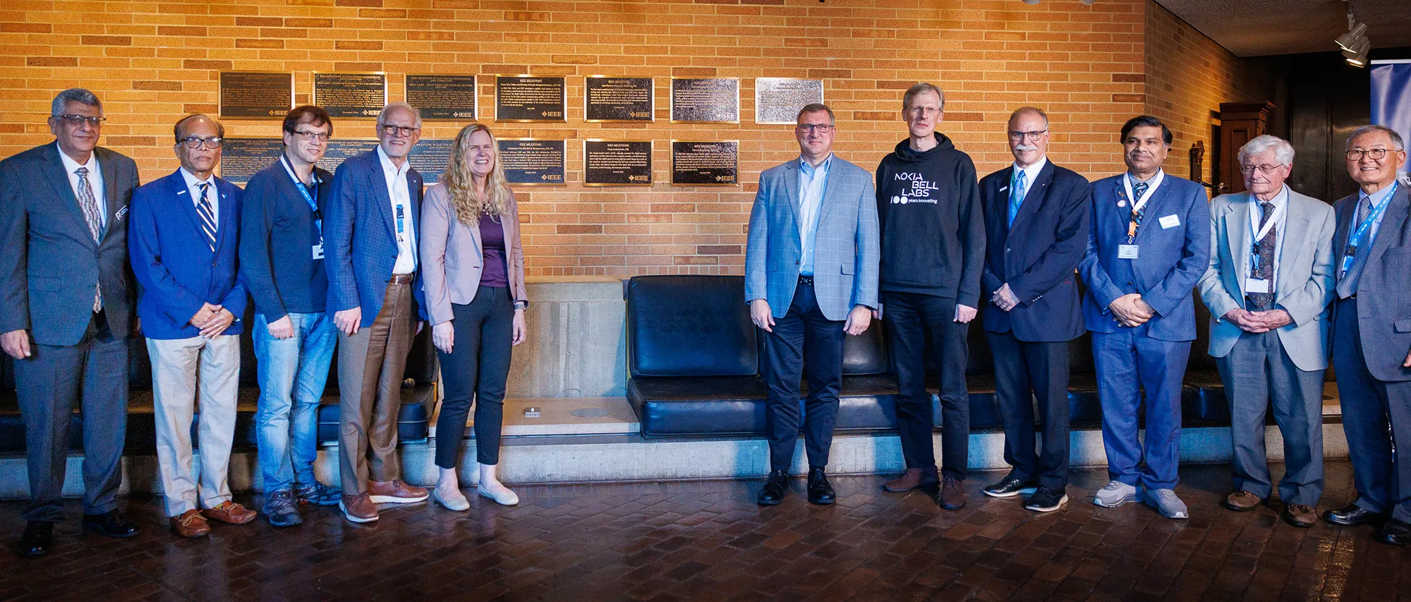 IEEE President Kathleen Kramer (center) and Past President Tom Coughlin (fourth from left) with dignitaries at the Nokia Bell Labs milestones dedication